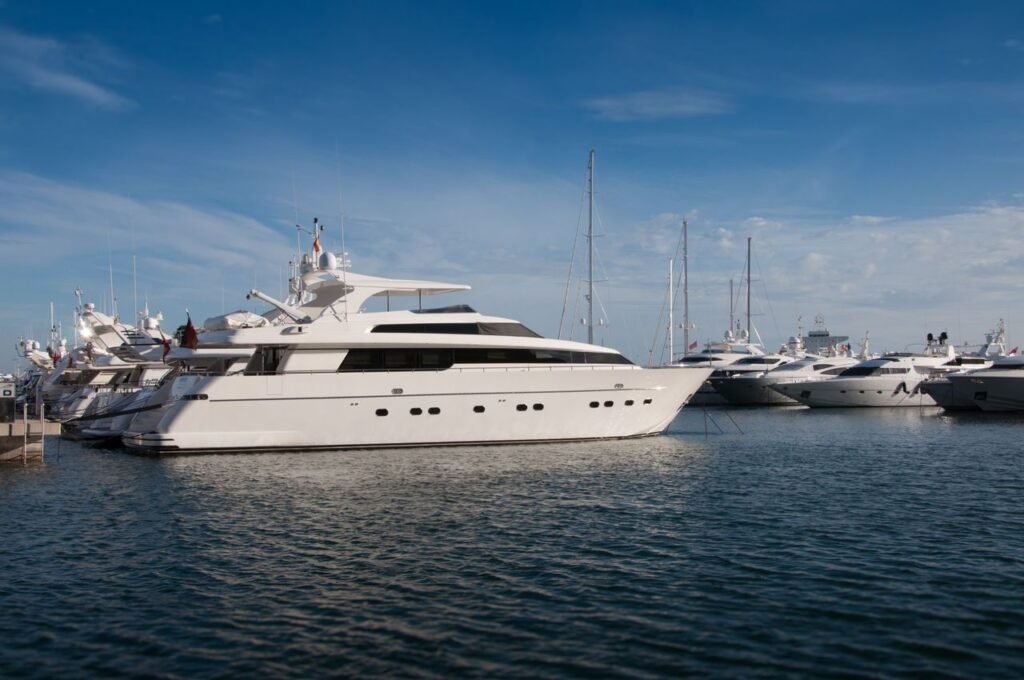 pexels-photo-42092-42092 A serene marina scene featuring luxury yachts docked under a clear blue sky.